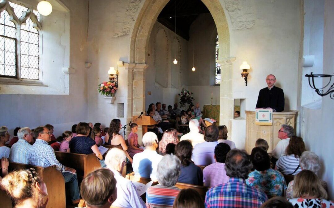 The Reverend David Green with parishioners in the beautiful church dating back to the 13th century. (c) Mike Rowe.