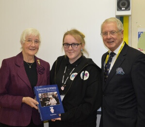Ann West DL, pictured left, presenting a copy of 'Unconquered' to the Head Girl at Walderslade School, and pictured right is Cllr Mike O Brien. (c) Dr Fraser Campbell.